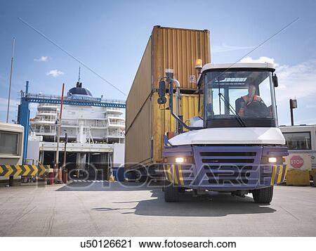 Truck unloading containers from ferry to port View Large Photo Image Stock Image - Truck unloading containers from ferry to port. Fotosearch