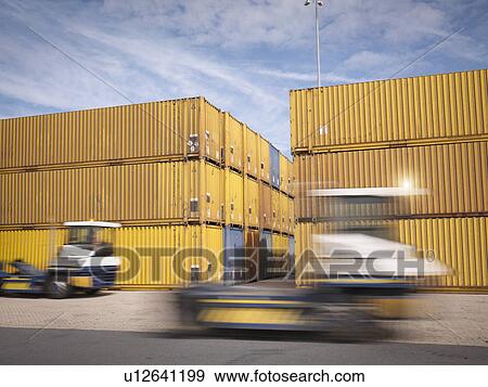 Trucks and shipping containers in port View Large Photo Image Stock Photo - Trucks and shipping containers in port. Fotosearch