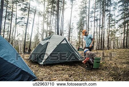 Two boys preparing tent for forest camping View Large Photo Image Stock Image - Two boys preparing tent for forest camping. Fotosearch
