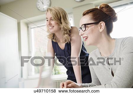 Stock Photo - Two businesswoman in meeting. Fotosearch