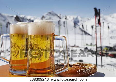 Stock Photograph - Two glasses of beer on outdoor cafe table, Austria. Fotosearch