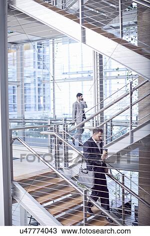 Two young businessmen on conference centre stairway View Large Photo Image Stock Image - Two young businessmen on conference centre stairway. Fotosearch