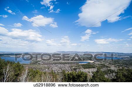 Stock Photograph - View of forest, mountains and lakes. Fotosearch