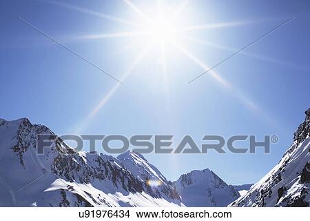 Picture - View of snow covered mountains in sunlight, Austria. Fotosearch