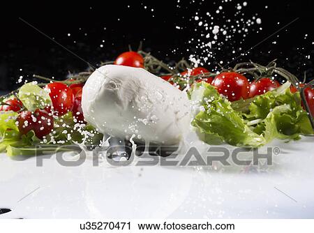 Vine tomatoes, mozzarella and lettuce leaf splashing into milk View Large Photo Image Stock Image - Vine tomatoes, mozzarella and lettuce leaf splashing into milk. Fotosearch