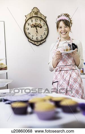 Woman holding up plate of homemade cupcakes View Large Photo Image Stock Photo - Woman holding up plate of homemade cupcakes. Fotosearch