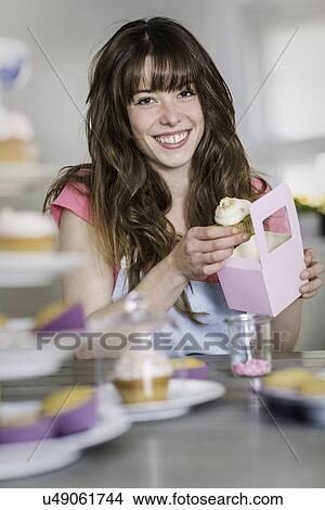 Woman packing homemade cupcakes View Large Photo Image Picture - Woman packing homemade cupcakes. Fotosearch