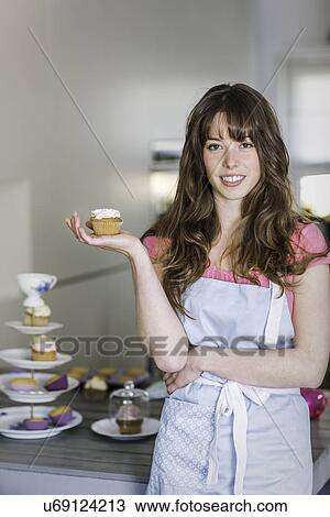 Woman posing with cupcakes View Large Photo Image Stock Image - Woman posing with cupcakes. Fotosearch