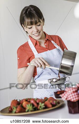 Woman pouring strawberry jam into jar View Large Photo Image Stock Photo - Woman pouring strawberry jam into jar. Fotosearch