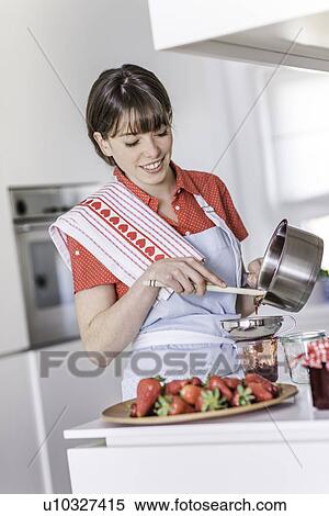 Woman pouring strawberry jam into jar View Large Photo Image Stock Photography - Woman pouring strawberry jam into jar. Fotosearch