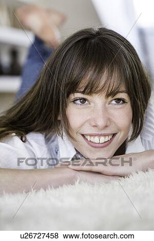 Woman relaxing on carpet View Large Photo Image Stock Photo - Woman relaxing on carpet. Fotosearch