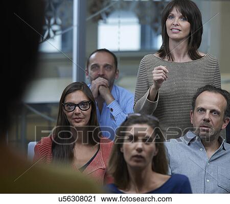 Woman standing in middle of group View Large Photo Image Stock Image - Woman standing in middle of group. Fotosearch