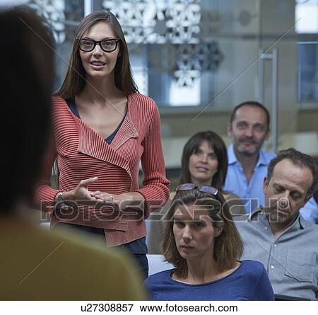 Woman standing in middle of group View Large Photo Image Stock Photo - Woman standing in middle of group. Fotosearch