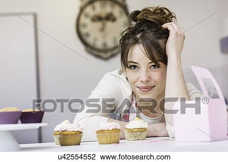 Woman with her cupcakes View Large Photo Image Stock Image - Woman with her cupcakes. Fotosearch