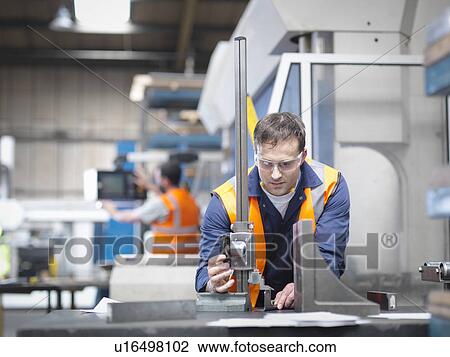 Worker measuring parts in sheet metal factory View Large Photo Image Stock Image - Worker measuring parts in sheet metal factory. Fotosearch