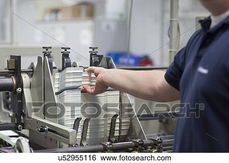 Worker using machine in paper packaging factory View Large Photo Image Stock Photograph - Worker using machine in paper packaging factory. Fotosearch