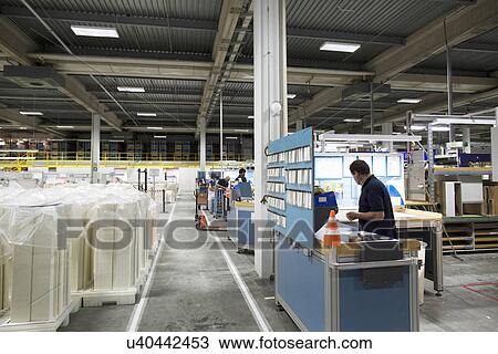 Stock Image - Workers in paper packaging factory. Fotosearch
