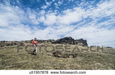 Stock Photo - Young adult woman hiking on mountain. Fotosearch