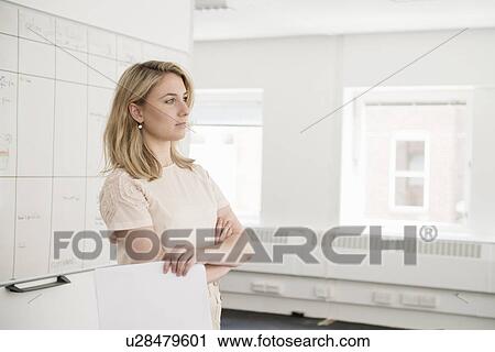 Young businesswoman contemplating in office View Large Photo Image Stock Image - Young businesswoman contemplating in office. Fotosearch