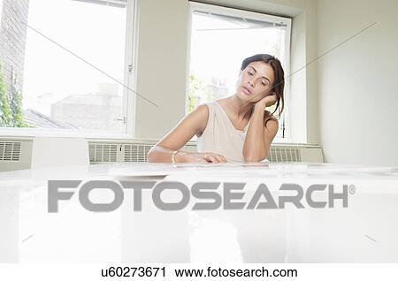 Young businesswoman looking stressed in office View Large Photo Image Stock Image - Young businesswoman looking stressed in office. Fotosearch