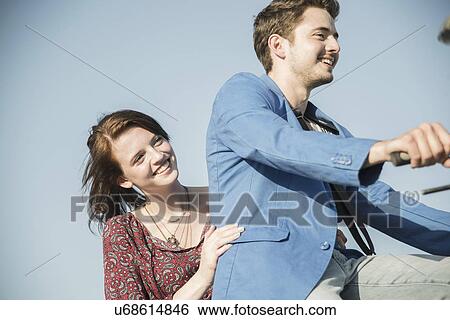 Young couple sharing bicycle ride View Large Photo Image Stock Photograph - Young couple sharing bicycle ride. Fotosearch