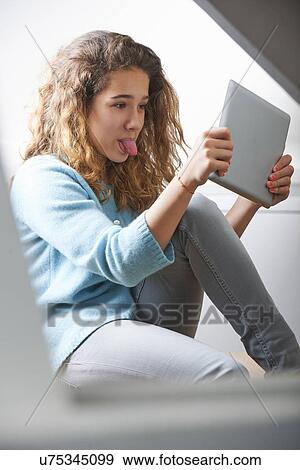 Young girl using digital tablet View Large Photo Image Stock Photo - Young girl using digital tablet. Fotosearch