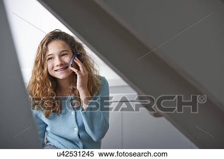Young girl using mobile phone View Large Photo Image Stock Photography - Young girl using mobile phone. Fotosearch