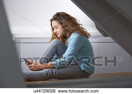 Stock Photo - Young girl with brown hair, smiling, portrait. Fotosearch