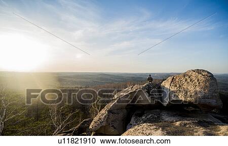 Young male hiker on top of rock formation View Large Photo Image Stock Image - Young male hiker on top of rock formation. Fotosearch