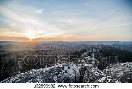Young male hiker on top of rock formation at sunset View Large Photo Image Stock Image - Young male hiker on top of rock formation at sunset. Fotosearch