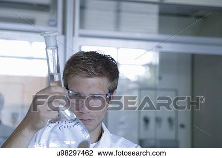 Young male scientist analyzing volumetric flask in lab View Large Photo Image Stock Image - Young male scientist analyzing volumetric flask in lab. Fotosearch