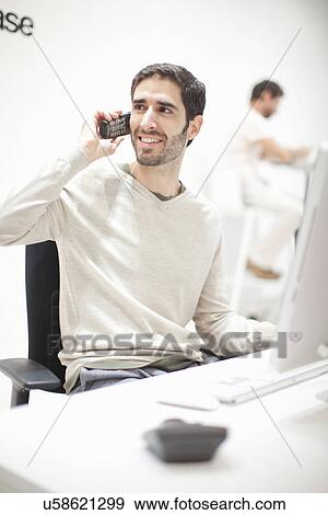 Stock Photo - Young man on telephone. Fotosearch
