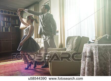 Young vintage couple dancing rock n roll in sitting room View Large Photo Image Stock Image - Young vintage couple dancing rock n roll in sitting room. Fotosearch