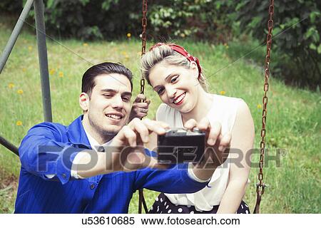 Young vintage couple taking selfie camera in garden View Large Photo Image Stock Photography - Young vintage couple taking selfie camera in garden. Fotosearch