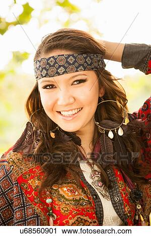 Stock Image - Young woman wearing hippy clothing. Fotosearch