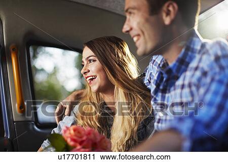 Young woman with boyfriend and bunch of roses in city taxi View Large Photo Image Stock Image - Young woman with boyfriend and bunch of roses in city taxi. Fotosearch