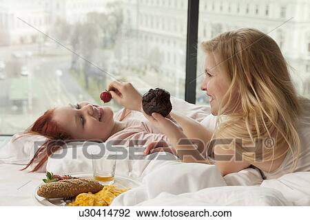 Young women having breakfast in bed, Vienna, Austria View Large Photo Image Stock Image - Young women having breakfast in bed, Vienna, Austria. Fotosearch