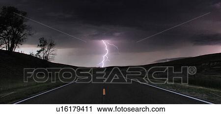 A single cloud-to-ground bolt lands at the end of a rural road, Lexington, Nebraska, USA View Large Photo Image Stock Image - A single cloud-to-ground bolt lands at the end of a rural road, Lexington, Nebraska, USA. Fotosearch