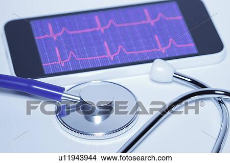 Picture - An acoustic stethoscope and smartphone screen displaying an electrocardiogram. Fotosearch