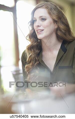Attractive young woman sitting at restaurant table View Large Photo Image Stock Photography - Attractive young woman sitting at restaurant table. Fotosearch