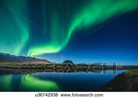 Stock Photo - Aurora Borealis above Grundarfjordur, Mt. Kikjufell in centre, Snaefellsnes, Iceland. Fotosearch