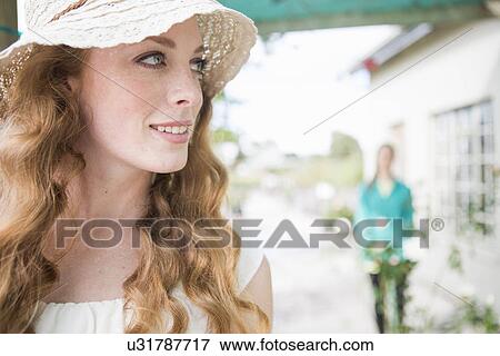 Beautiful young woman in rose garden centre View Large Photo Image Stock Photo - Beautiful young woman in rose garden centre. Fotosearch