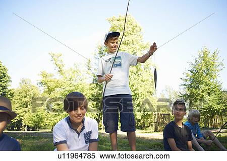 Stock Photography - Boy holding fishing net with fish. Fotosearch