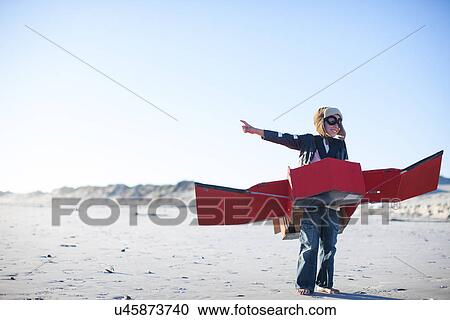 Boy standing with toy airplane and pointing on beach View Large Photo Image Stock Image - Boy standing with toy airplane and pointing on beach. Fotosearch