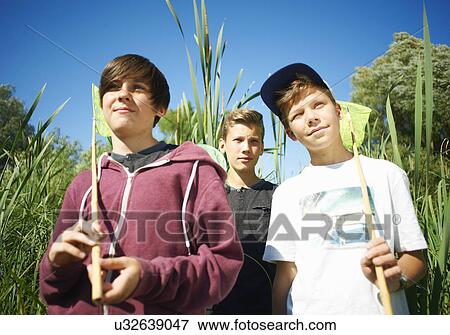 Stock Photo - Boys holding fishing nets. Fotosearch