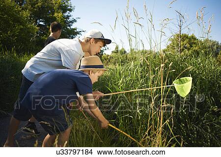 Picture - Boys using fishing nets. Fotosearch