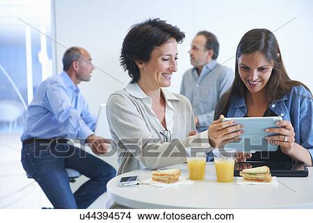 Business people having discussion over lunch View Large Photo Image Picture - Business people having discussion over lunch. Fotosearch