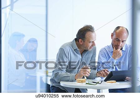 Business people having discussion over lunch View Large Photo Image Stock Photography - Business people having discussion over lunch. Fotosearch