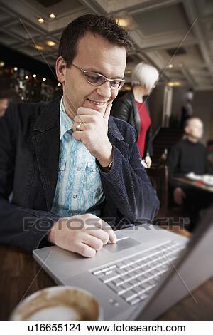 Picture - Businessman using laptop. Fotosearch