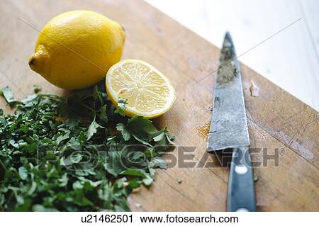 Stock Image - Chopped parsley and lemon. Fotosearch